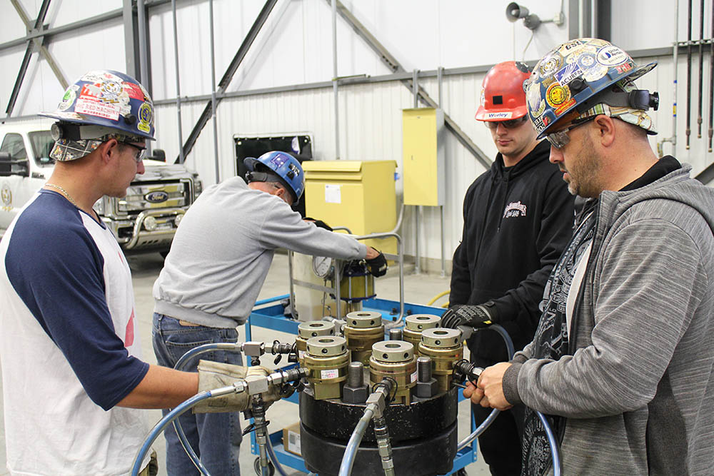 Instructors working on the torqueing & tensioning equipment